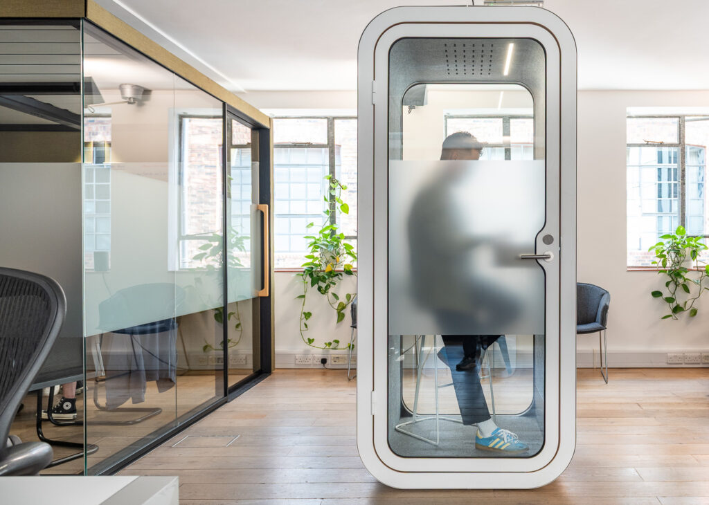 Professional using a private phone booth at eOffice flexible workspace in London